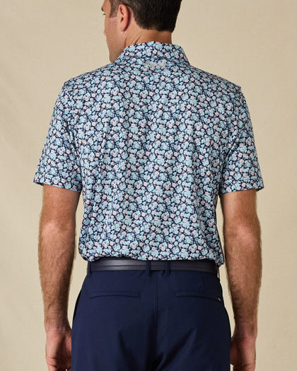 Back view of the Point Reyes Polo in Mint Tea, highlighting the all-over floral pattern and embroidered logo below the collar.
