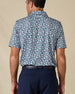 Back view of the Point Reyes Polo in Mint Tea, highlighting the all-over floral pattern and embroidered logo below the collar.