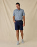 Model wearing the Point Reyes Polo in Mint Tea with navy golf shorts, a coordinating belt, and gray sneakers.