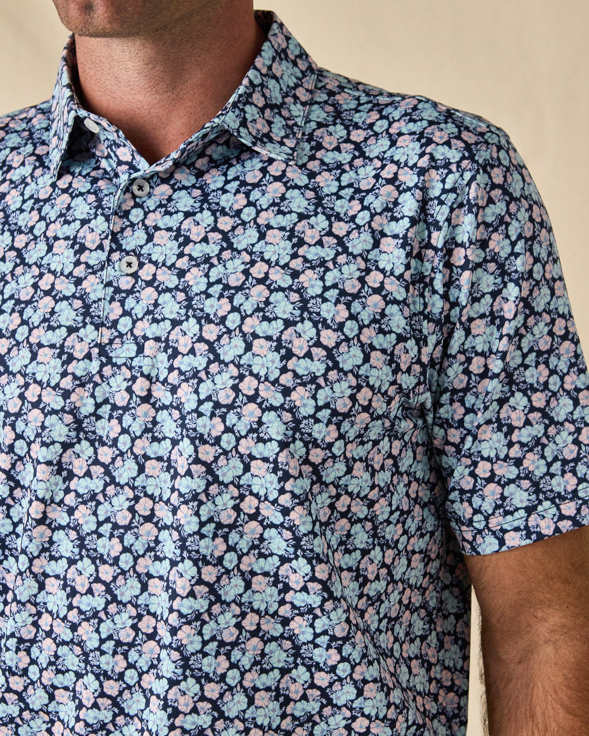 Close-up of the Point Reyes Polo in Mint Tea, highlighting the floral print, classic collar, and button placket.