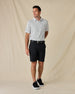Model wearing the Siesta Polo in Herb with black shorts, a black belt, and black sneakers.