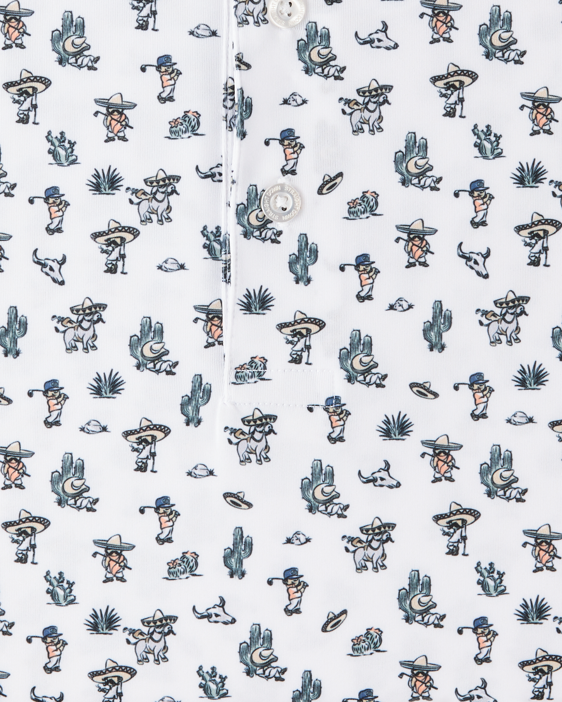 Close-up of the Siesta Polo showing the white fabric, button placket, and colorful Western-inspired print with golfers, cacti, and desert motifs.
