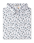 Folded white Siesta Polo featuring an allover Western-inspired print with golfers, cacti, sombreros, and desert motifs.