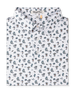 Folded white Siesta Polo featuring an allover Western-inspired print with golfers, cacti, sombreros, and desert motifs.
