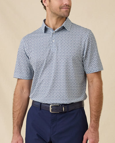 Model wearing the Date Palm Polo in New Indigo featuring a micro palm tree print