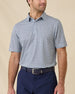 Model wearing the Date Palm Polo in New Indigo featuring a micro palm tree print