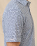 Sleeve detail of the Date Palm Polo in New Indigo highlighting the palm tree print and Straight Down logo tab