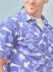 Islamorada Full Button Polo in Skipper, on model close-up front view highlighting the all-over white nautical print of marlin, sailfish, coral, and palm trees on a blue base