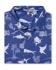 Islamorada Full Button Polo in Skipper, folded flat lay front view featuring a blue base with an all-over white nautical print of marlin, sailfish, coral, palm trees, and fishing rods