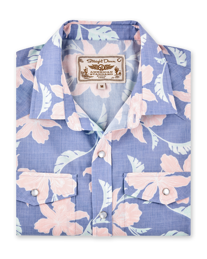 Folded blue short-sleeve shirt with a pink floral print, pearl snap buttons and dual chest pockets.