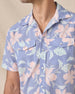 Close-up of the blue floral shirt’s open collar, pearl snap front and dual chest pockets.