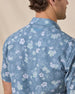 Close-up of the Celadine Woven Shirt showing the floral print and embroidered logo below the back collar.
