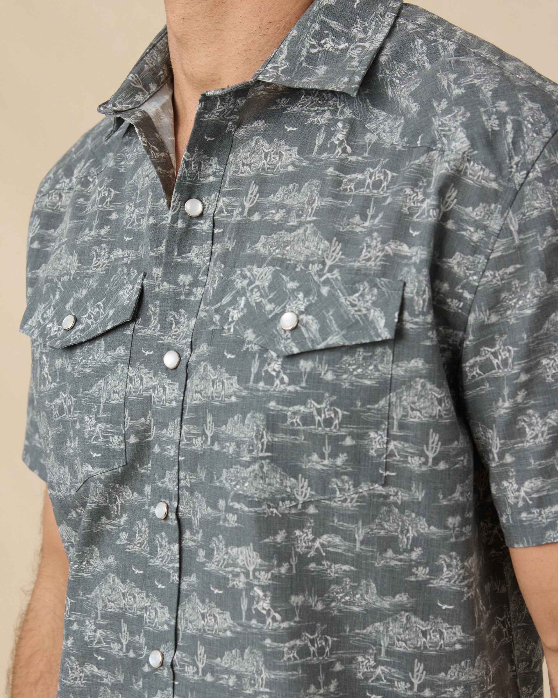 Close-up of the Out West Woven Shirt showing the western print, pearl snap buttons, and chest pockets.