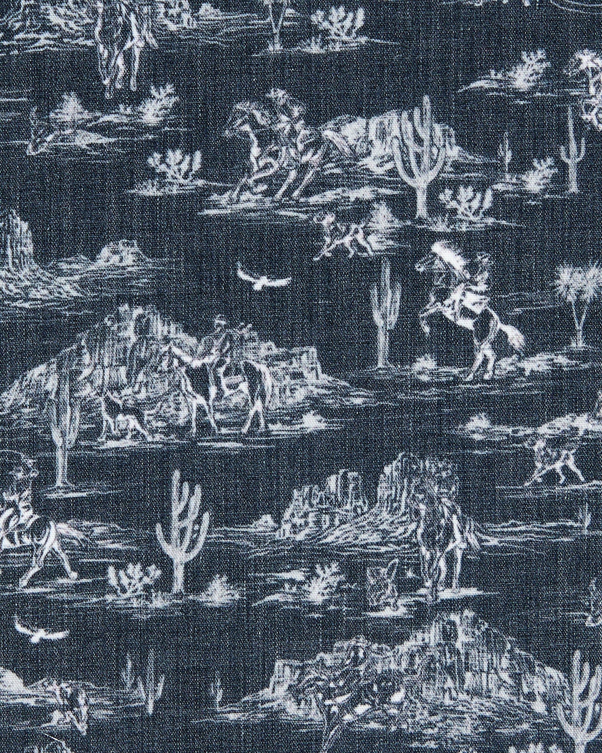 Close-up of the Out West Woven Shirt fabric featuring a tonal western desert scene with cacti, mesas, and cowboys.