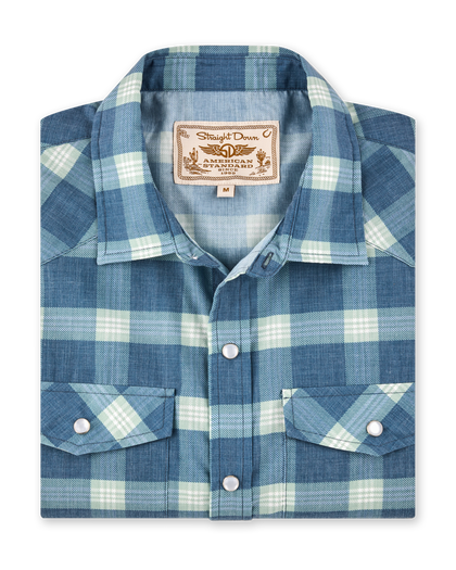 Folded Jasper Woven Shirt in Moonlight featuring a blue and light green plaid pattern, pearl snap buttons, and western-inspired detailing.