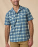 Man wearing the Jasper Woven Shirt in Moonlight, featuring a short-sleeve plaid design, pearl snap front, and two chest pockets.