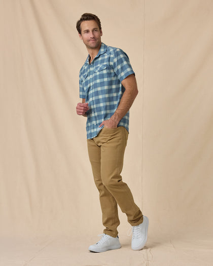 Man wearing the Jasper Woven Shirt in Moonlight with tan pants and white sneakers.