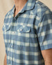 Close-up of the Jasper Woven Shirt in Moonlight showing the plaid pattern, pearl snap buttons, western yoke, and flap chest pockets.