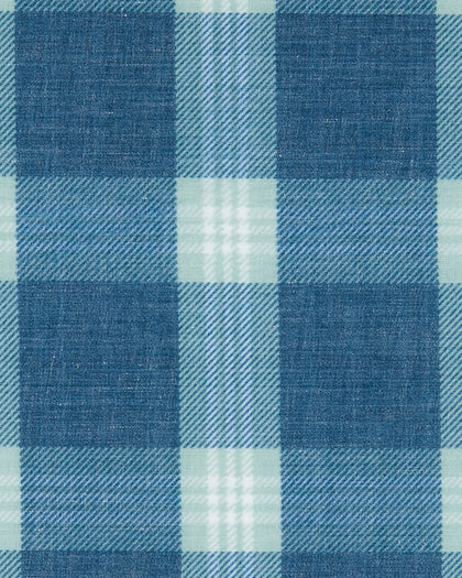 Close-up of the Jasper Woven Shirt fabric showing the blue and light green plaid pattern and woven texture.
