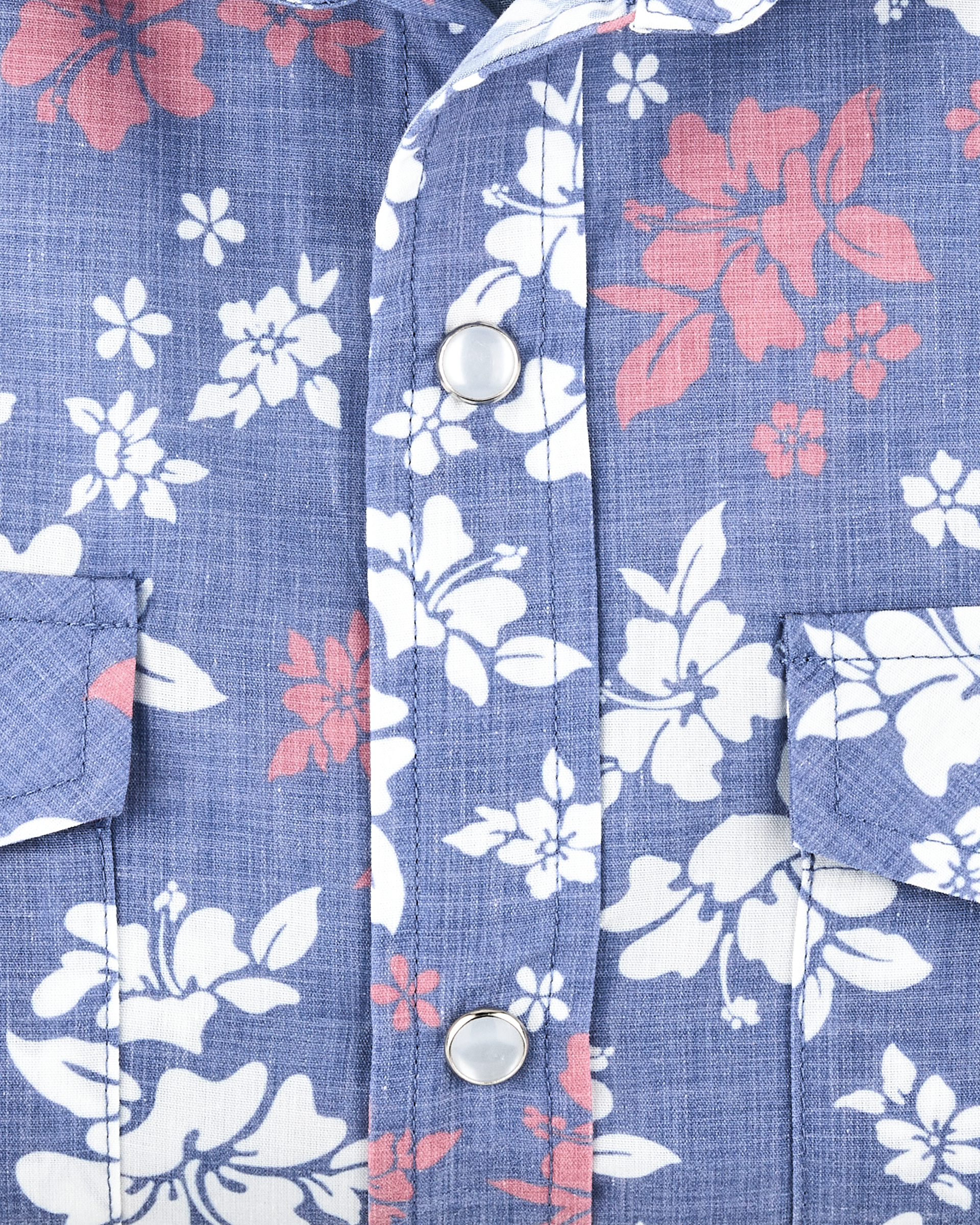 Close-up of the Paniolo Woven Shirt in Tidal Blue showcasing the hibiscus print, lightweight broadcloth fabric, and pearl snap button placket