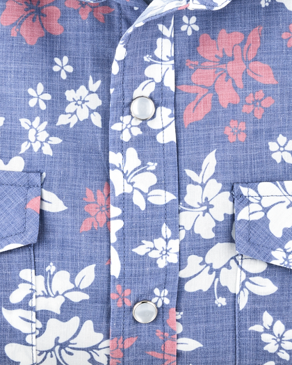 Close-up of the Paniolo Woven Shirt in Tidal Blue showcasing the hibiscus print, lightweight broadcloth fabric, and pearl snap button placket