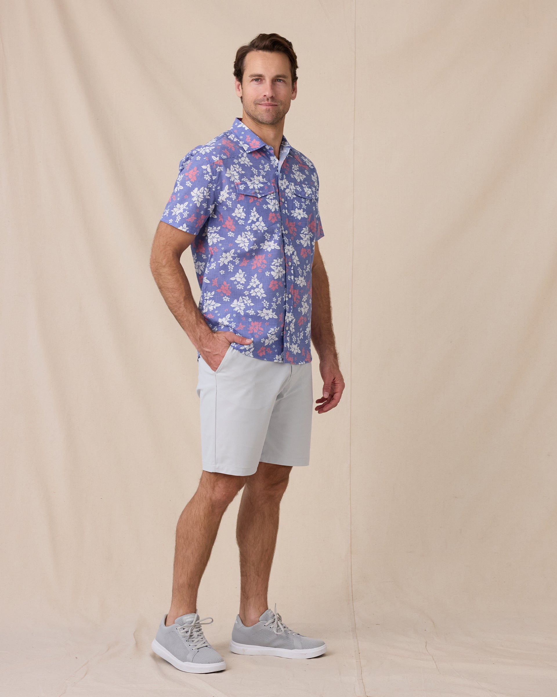 Model wearing the Paniolo Woven Shirt in Tidal Blue styled with light gray shorts