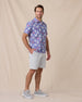 Model wearing the Paniolo Woven Shirt in Tidal Blue styled with light gray shorts