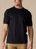 Men's Luxe Tee in Black, on model front view featuring a black short sleeve crew neck tee