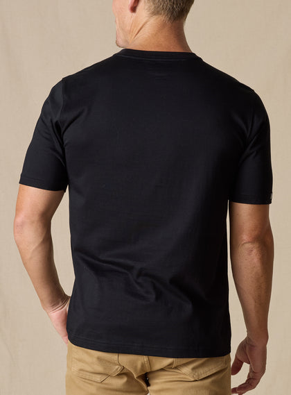 Men's Luxe Tee in Black, on model back view featuring a black short sleeve crew neck tee