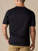 Men's Luxe Tee in Black, on model back view featuring a black short sleeve crew neck tee