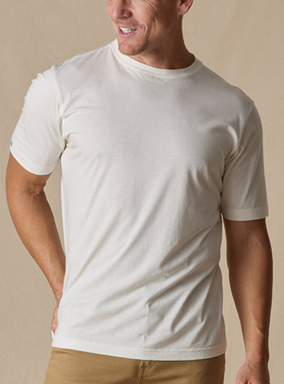 Men's Luxe Tee in Cream, on model front view featuring a cream short sleeve crew neck tee with a  Straight Down woven label at the left sleeve