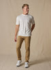 Men's Luxe Tee in Cream, on model full body front view featuring a cream short sleeve crew neck tee with a  Straight Down woven label at the left sleeve styled with tan pants and white shoes