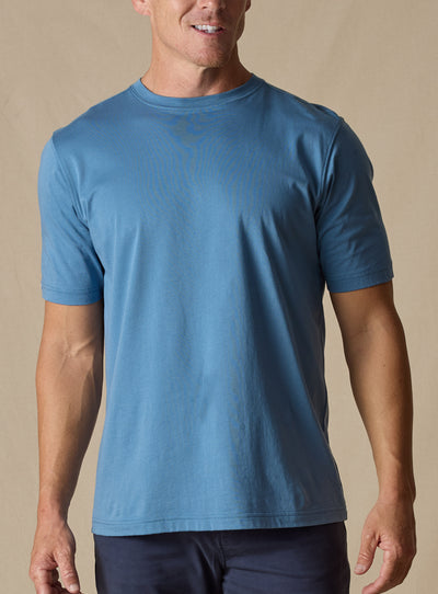 Men's Luxe Tee in Petrol, on model front view featuring a medium blue short sleeve crew neck tee 