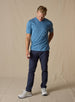 Men's Luxe Tee in Petrol, on model full body front view featuring a medium blue short sleeve crew neck tee styled with navy pants and white shoes