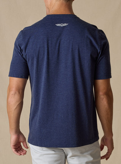 Marlin Rodeo Graphic Tee in New Indigo, back model view featuring a heathered navy short-sleeve crewneck tee with Straight Down logo at the upper back neckline, paired with light grey pants