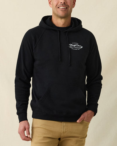 Men's Club Pro Hoodie in Black, front view on model featuring the Straight Down Golf Company "Established 1989" logo on the left chest with kangaroo pocket, paired with tan pants