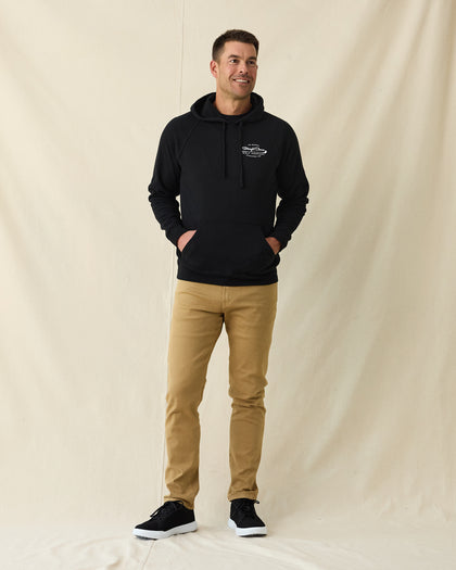 Men's Club Pro Hoodie in Black, full length front view on model featuring the Straight Down Golf Company "Established 1989" logo on the left chest with kangaroo pocket, paired with tan pants and black shoes