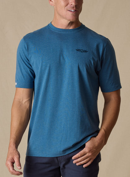 Vegas Vacation Graphic Tee in Petrol, front model view featuring a heathered blue short-sleeve crewneck tee with a Straight Down logo at the left chest, paired with navy pants