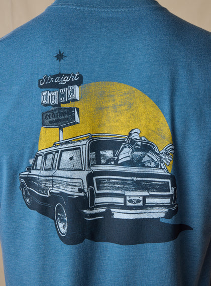 Vegas Vacation Graphic Tee in Petrol, close-up back graphic detail view highlighting a vintage-style illustration of a classic woody wagon loaded with golf clubs parked in front of a golden sun and retro roadside 