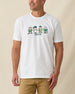 Men's IYKYK Tee in White, front view on model featuring a white base with a four golf gnome character graphic and IYKYK text in green on the chest, paired with khaki pants