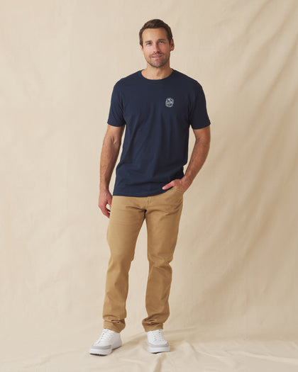 Men wearing navy graphic t-shirt with khaki pants and white sneakers