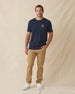 Men wearing navy graphic t-shirt with khaki pants and white sneakers