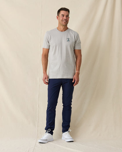 Men's Alligator Alley Tee in Light Grey, full length model view featuring a light grey short sleeve crewneck tee with the Straight Down Golf Company Est. 1989 alligator graphic paired with navy pants and white shoes