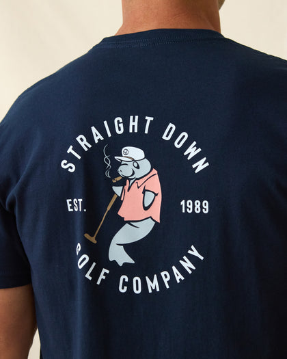 Men's Mana-Tee in Navy, close-up back view on model highlighting the large circular Straight Down Golf Company Est. 1989 graphic featuring a cigar-smoking manatee in a pink polo shirt holding a golf club