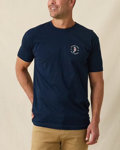 Men's Mana-Tee in Navy, front view on model featuring a small circular Straight Down Golf Company Est. 1989 graphic with manatee character on left chest, paired with khaki pants