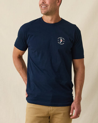 Men's Mana-Tee in Navy, front view on model featuring a small circular Straight Down Golf Company Est. 1989 graphic with manatee character on left chest, paired with khaki pants
