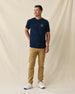Men's Mana-Tee in Navy, full length front view on model featuring a small circular Straight Down Golf Company Est. 1989 graphic on left chest, paired with khaki pants and white shoes