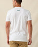 Men's Munch Tee in White, back view on model featuring a white base with a small Straight Down logo at upper back, paired with khaki pants