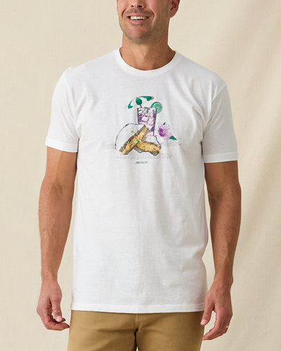 Men's Munch Tee in White, front view on model featuring a white base with a pimento cheese sandwich and iced drink graphic with MUNCH text on the chest, paired with khaki pants