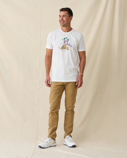 Men's Munch Tee in White, full length front view on model featuring a white base with a pimento cheese sandwich and iced drink graphic with MUNCH text on the chest, paired with khaki pants and white shoes